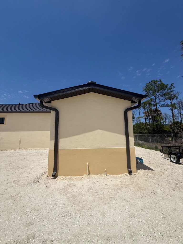 Downspout running down the corner of a house to its discharge point