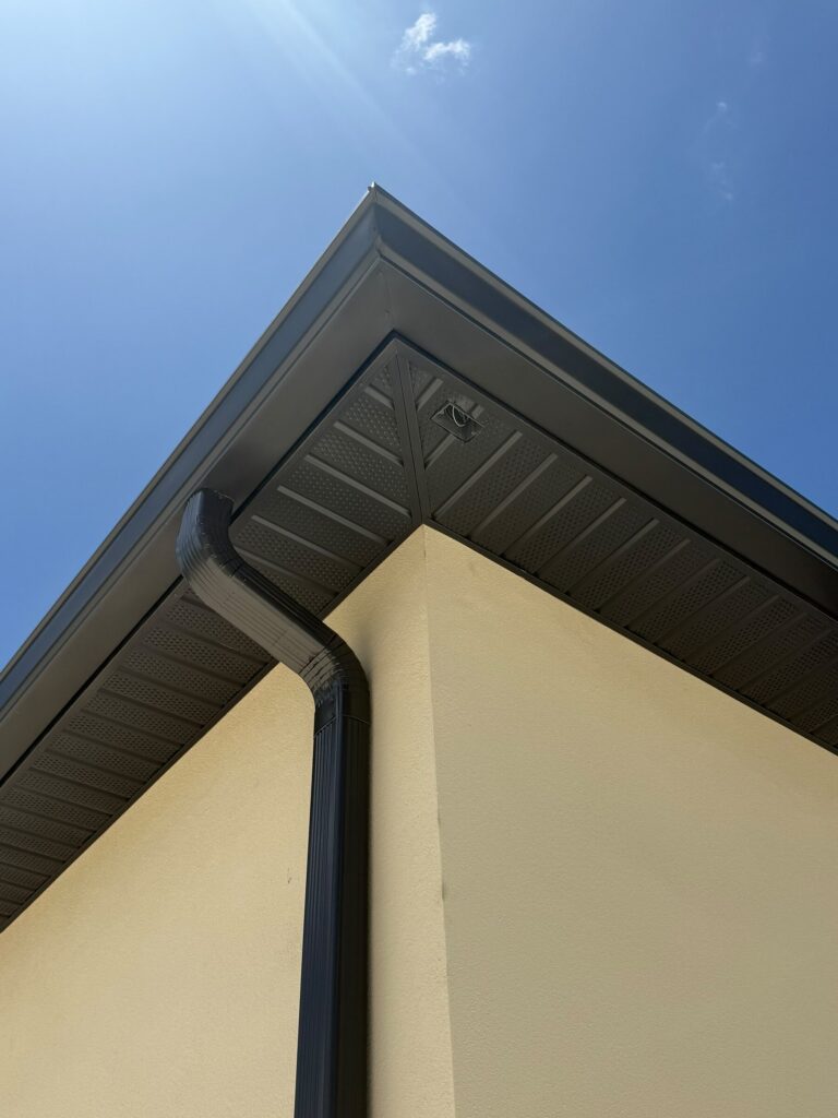 Downspout elbow joining the gutter at the corner of a house